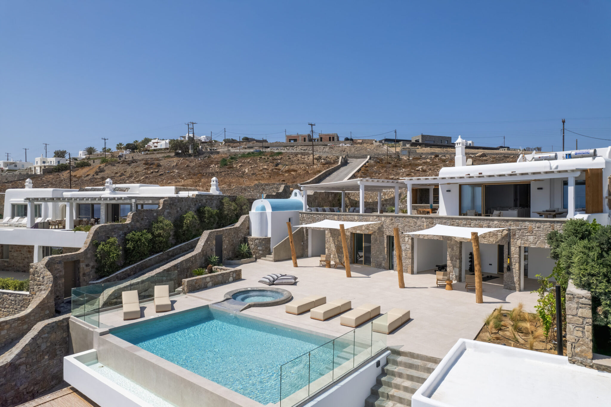 Pool terrace with sun loungers at Villa Zenith, Mykonos