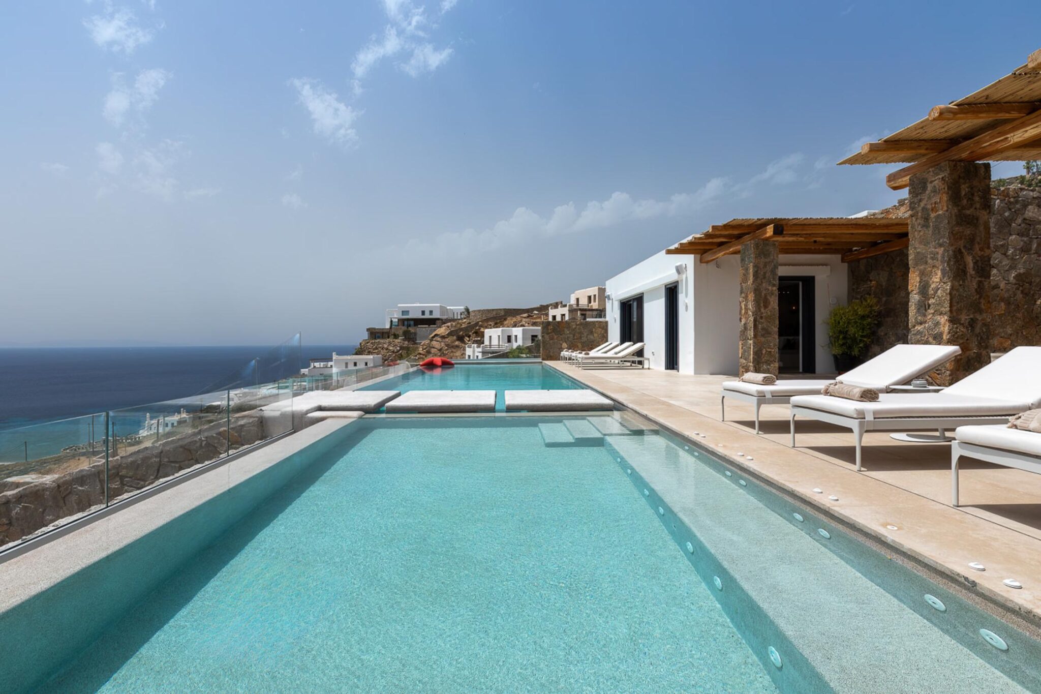 Infinity pool and sun loungers overlooking the sea at Villa Skyframe, Mykonos