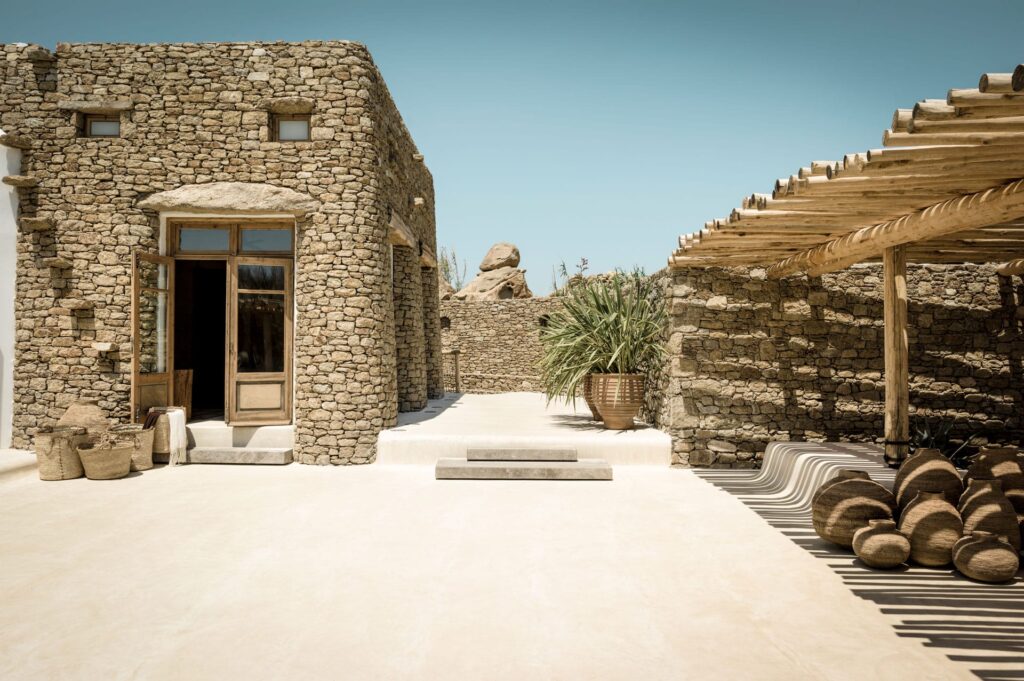 Stone courtyard and shaded seating at Scorpios Mykonos